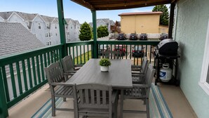 A covered patio with a table and chairs, a grill, and a gas cylinder. - Sleeps 15, 5BR, 2 Blocks to Convention Center & Beach, 2 Parking Spots (Wildwood)