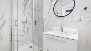Shower, hair dryer, towels, shampoo