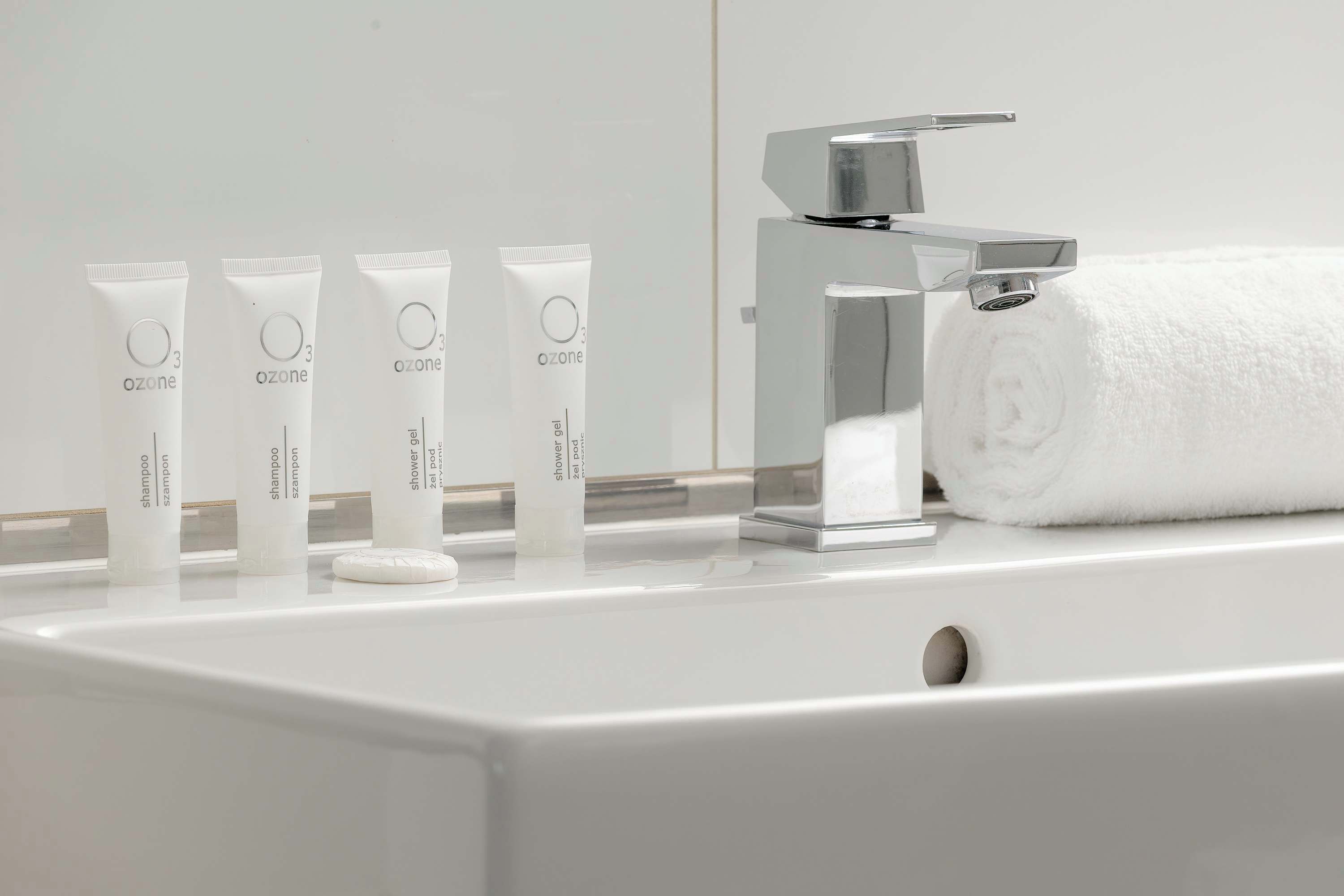 A bathroom sink with five white tubes labeled 'ozone' and a chrome faucet.