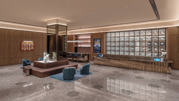 A modern lobby with a reception desk, seating area, and a large display of glassware. - Crystal Orange Tianjin Eye Ancient Culture Street (Tianjin)