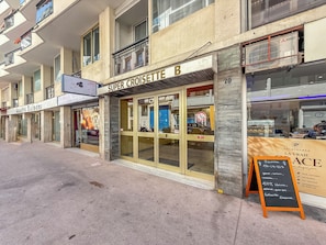 A storefront with a sign reading 'SUPER CROISETTE B' and a blackboard with menu items. - Renovated 1BR | Steps from Croisette & Beach (Cannes)