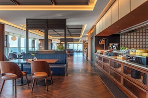 A modern restaurant interior with a bar area, seating, and a view through large windows. -  IntercityHotel Tianjin Binhai Yujiapu Financial District (Tianjin)