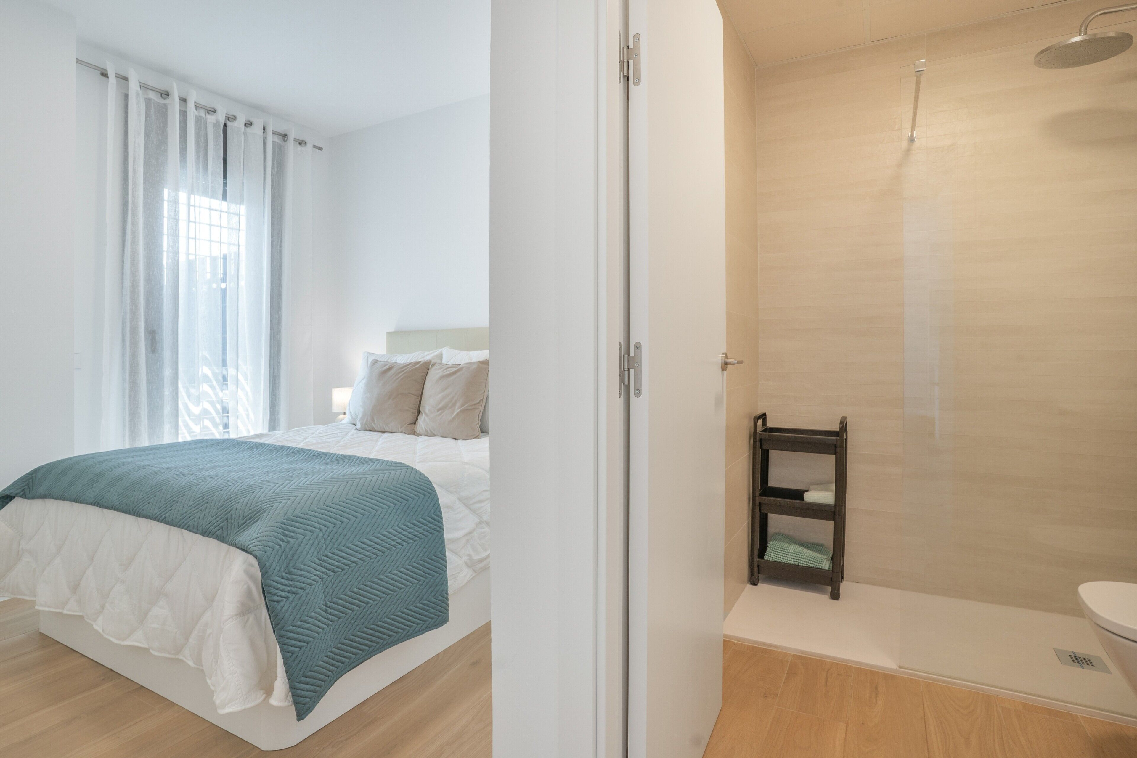 Una habitación de hotel con cama, ducha y váter.