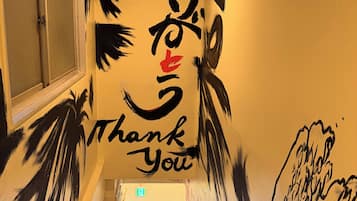 A staircase with a wall mural featuring abstract art and the words 'Thank You.'
