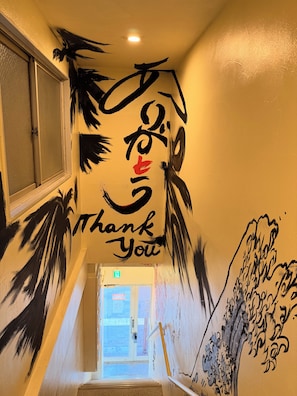 A staircase with a wall mural featuring abstract art and the words 'Thank You.' - To-Fu-rou (Osaka)