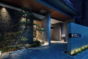 A modern hotel entrance with a stone facade, a signboard, and a well-lit pathway. - Anran Hotels&Resorts (OSAKA)