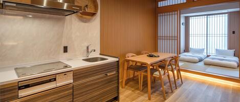 A modern kitchen with a built-in stove, a sink, and wooden cabinetry.
