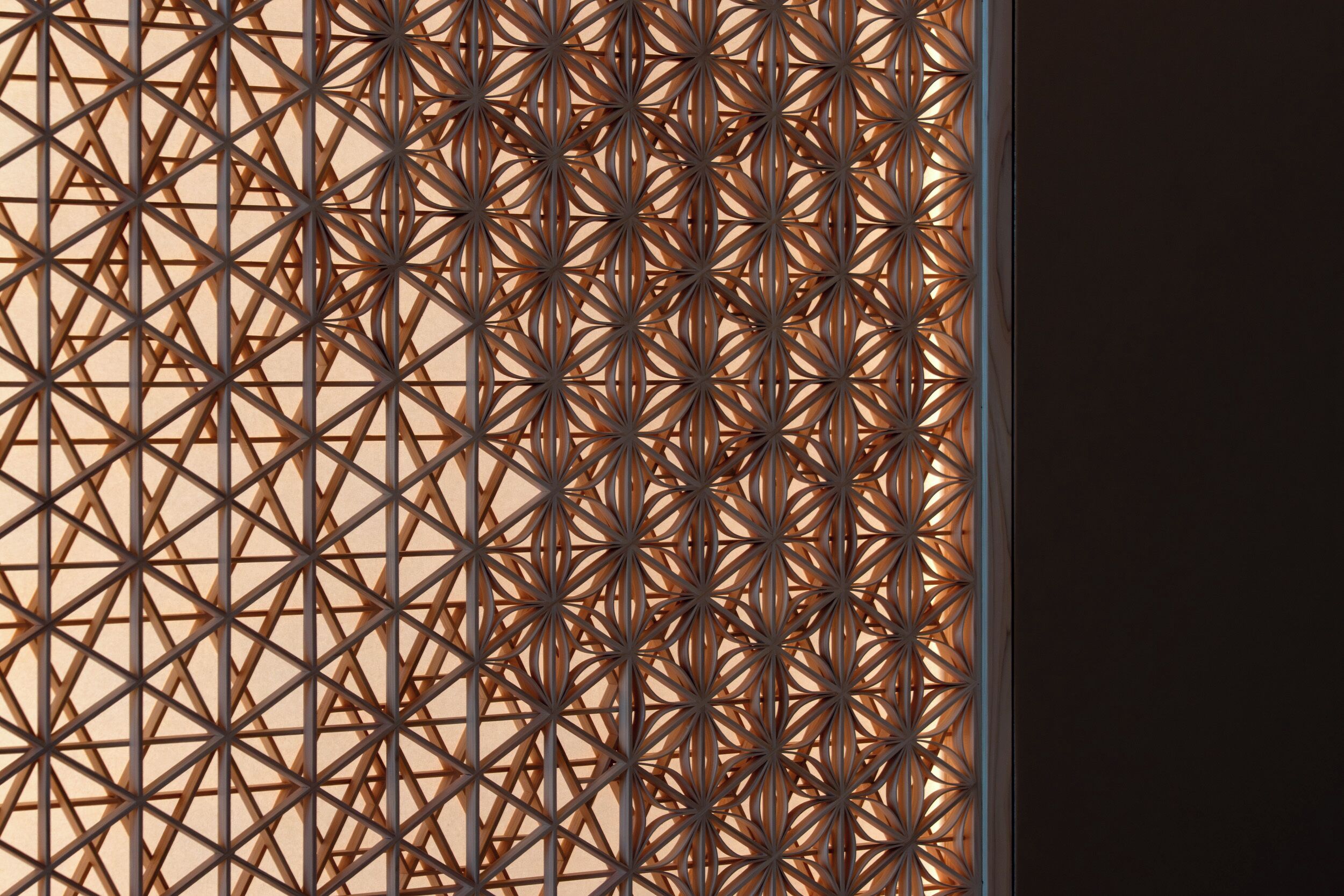 Eine geometrische Metallwand mit einem sich wiederholenden Muster.