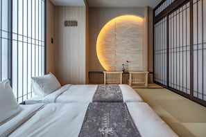 A hotel room with a large window, a bed with white bedding, a wooden headboard, and a wall with a large circular design. - Anran Hotels&Resorts (OSAKA)