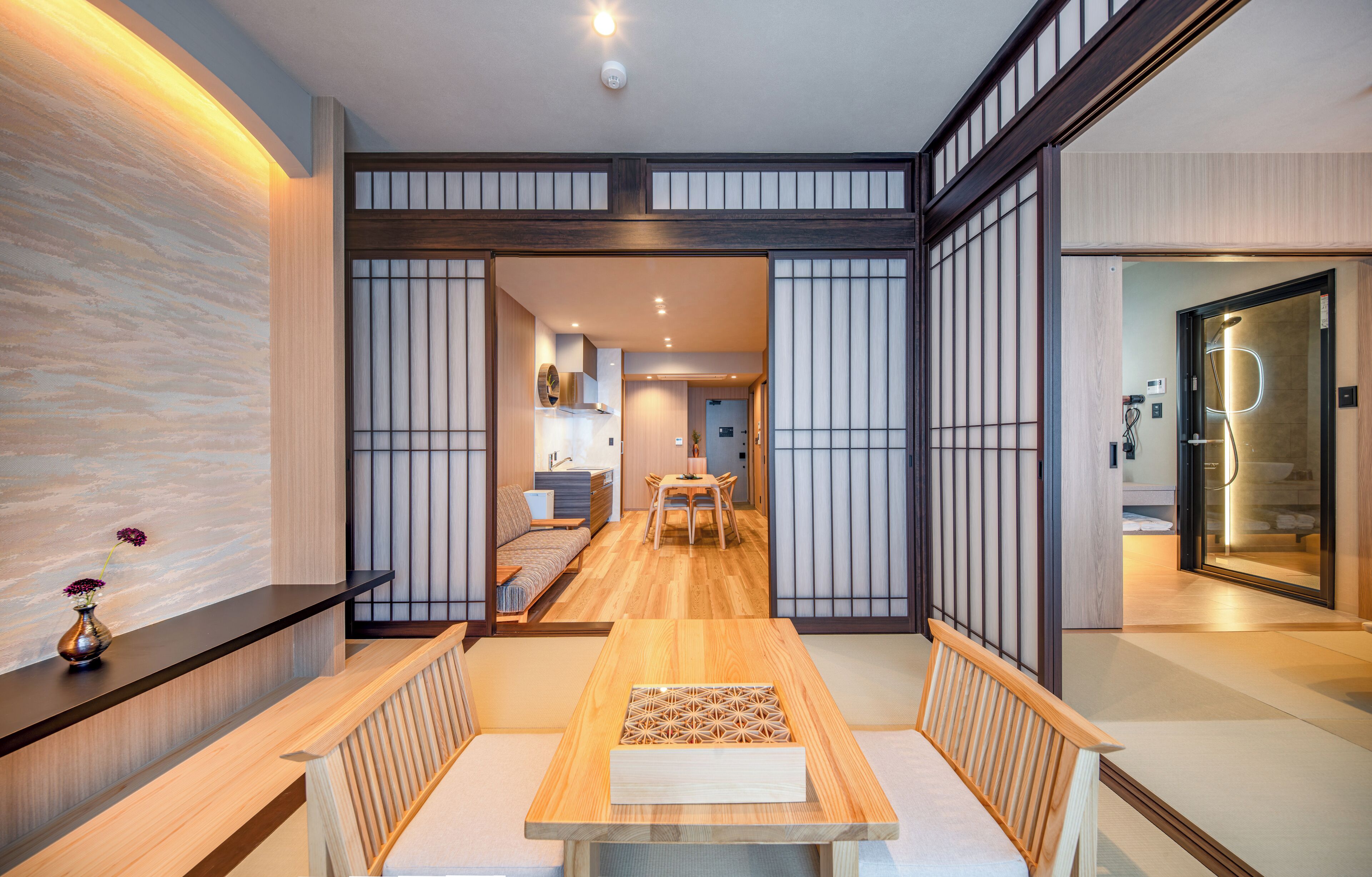A traditional Japanese interior with tatami flooring, a low wooden table, and shoji screens.