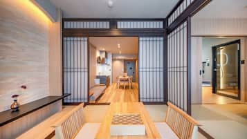 A traditional Japanese interior with tatami flooring, a low wooden table, and shoji screens.