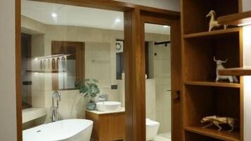 Separate bathtub and shower, towels, soap, shampoo