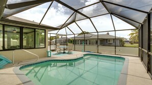 An indoor swimming pool with a covered area, clear pool water, and a view of the outside. - 4 Mi to Beaches! Family Getaway w/ Pool in Venice (Venice)
