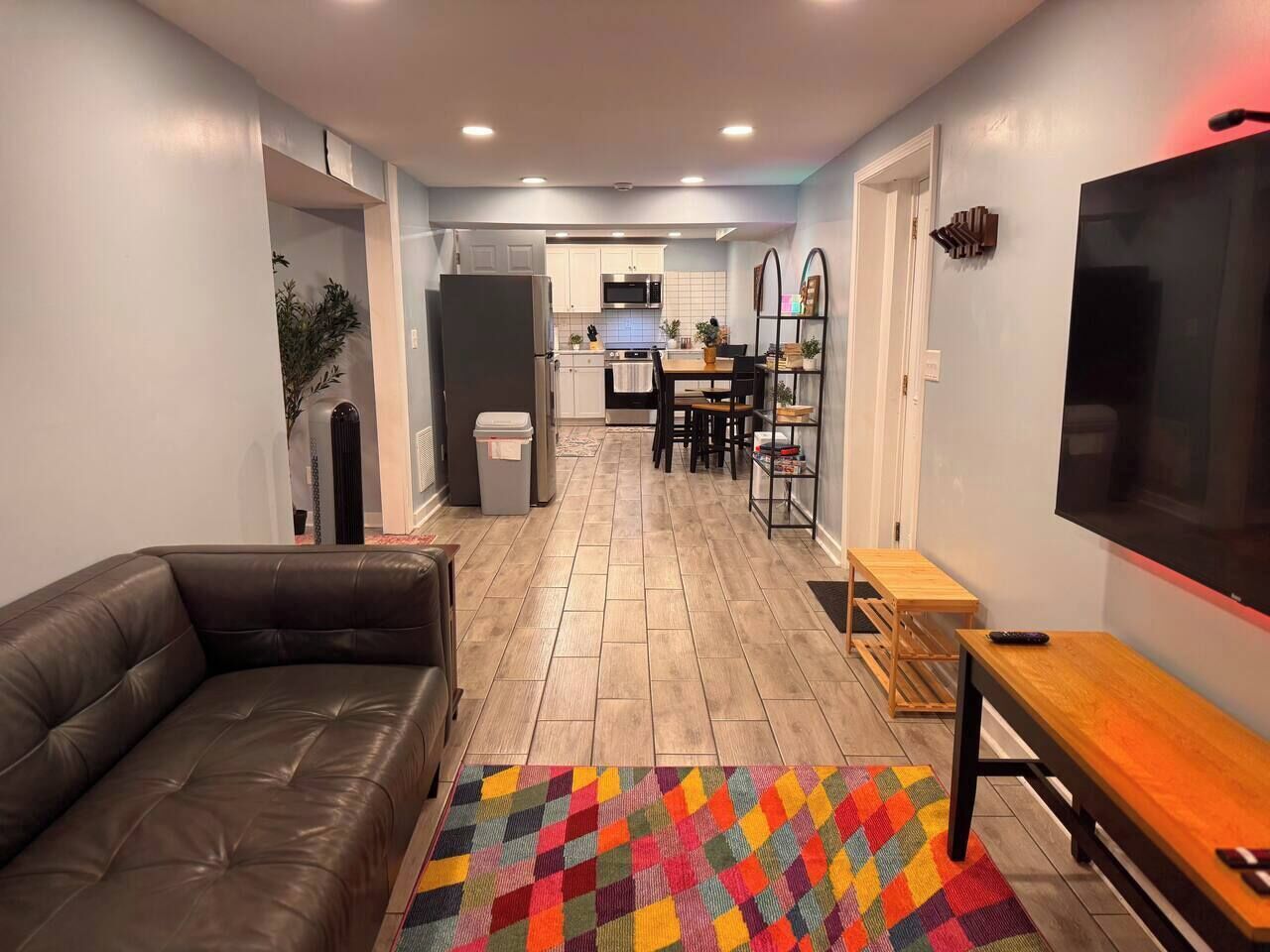 A living room with a sofa, a TV, and a wooden table.