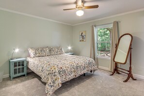 A bedroom with a bed, a nightstand, a mirror, and a window with curtains. - Family Getaway w/ Pool on 8 Acres in Carriere! (Carriere)