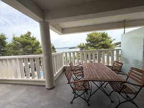 A covered outdoor seating area with a view of the sea. - Two Bedroom Sea View Apartment Marisol (Mrljane)