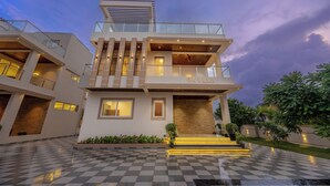 A modern multi-story villa with a checkered floor, a balcony, and a nameplate reading 'RK VILLA'. - ELIVAAS RK Villa 4BHK Hideaway with Pool (Lonavala)