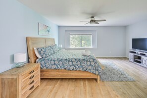 A bedroom with a bed, a nightstand, a TV stand, and a ceiling fan. - 9 Mi to Smith Rock SP! Family Home w/ Fenced Yard (Redmond)