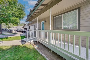 A residential building with a covered porch, a garage, and a driveway with a parked truck. - 9 Mi to Smith Rock SP! Family Home w/ Fenced Yard (Redmond)
