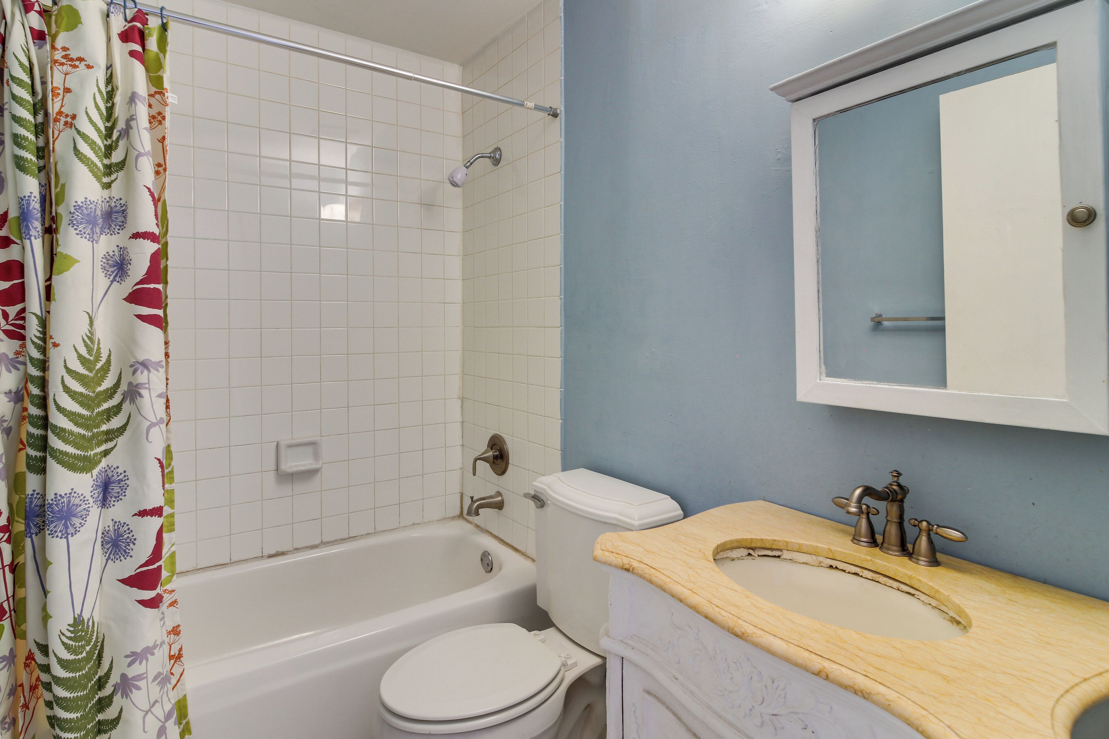 A bathroom with a bathtub, toilet, and sink.