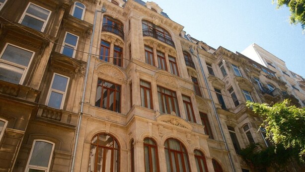 A multi-story building with classical architecture, featuring arched windows and decorative moldings. - Nazenin Hotel (Istanbul)