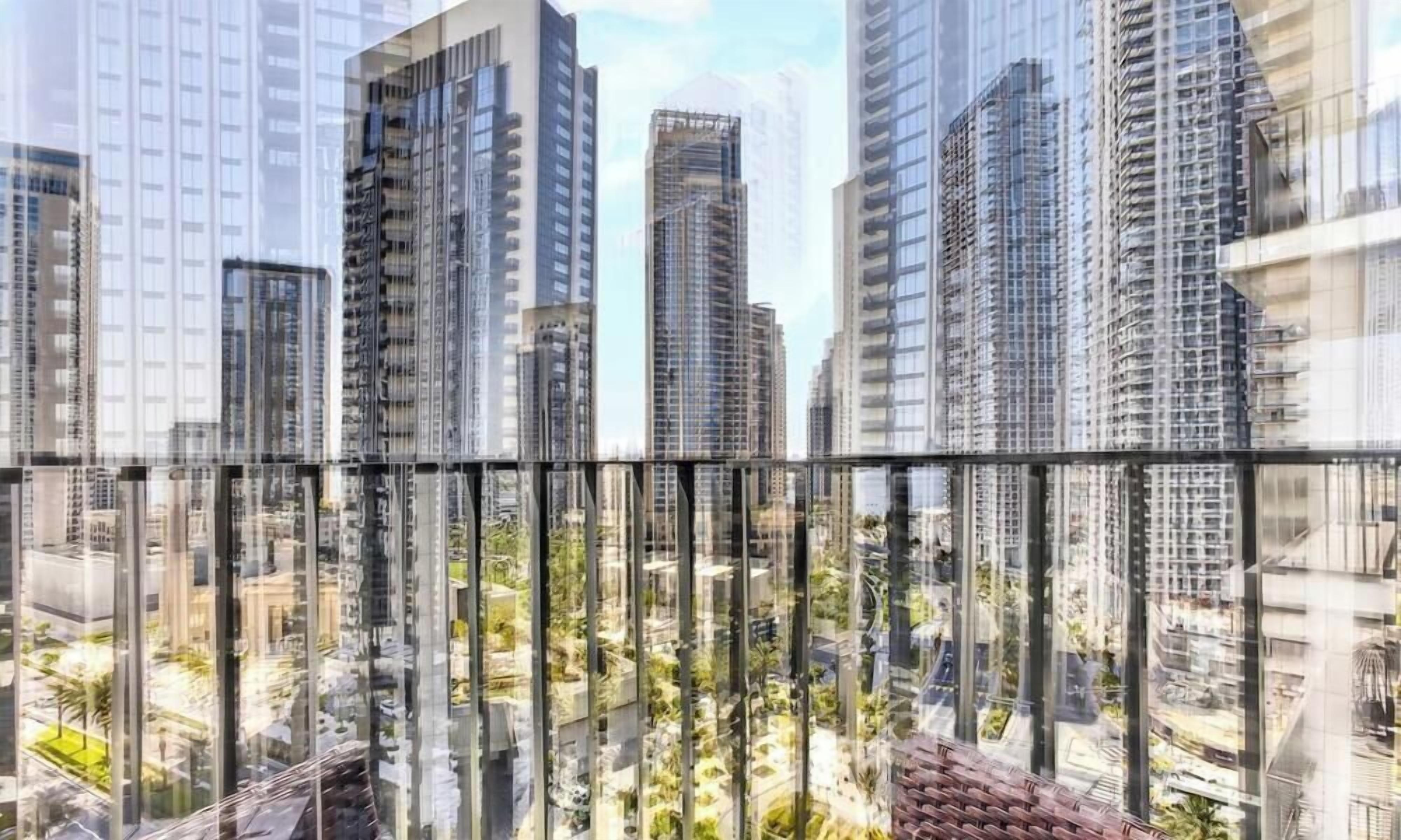 A high-rise building with multiple floors, large windows, and a view of a cityscape.
