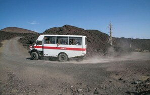 A white and red bus labeled 'STAR' driving on a dirt road with passengers visible through the windows. - Villa in Brucoli with 5 bedrooms sleeps 13 (Brucoli)
