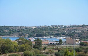 A coastal town with a marina, buildings, and hilly terrain. - Villa in Brucoli with 5 bedrooms sleeps 13 (Brucoli)