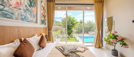 A bedroom with a bed, pillows, a large window with curtains, a view of a swimming pool, and a potted plant.