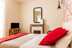 A bedroom with a bed, a desk with a computer, a fireplace, and a mirror. - Château Haut Cazevert Guesthouse with Private Pool, Wi-Fi, and Air Conditioning (Blasimon)
