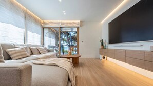 A modern bedroom with a large bed, a TV, and a view of the outdoors. - Can Costelles II - Mediterranean Gem with Sea View (Cambrils)