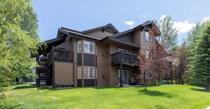 A two-story house with a balcony, a covered porch, and a well-maintained lawn. - 1 Car Garage | Gourmet Kitchen | On Bus Route (Steamboat Springs)