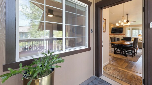 A wooden door leading to a dining area with a table and chairs. - 1 Car Garage | Gourmet Kitchen | On Bus Route (Steamboat Springs)