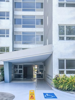 A modern building with a flat facade, large windows, and a covered entrance area. - Seawind Condominium (Davao City)