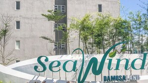 A high-rise building with multiple windows and a central stairwell. - Seawind Condominium (Davao City)