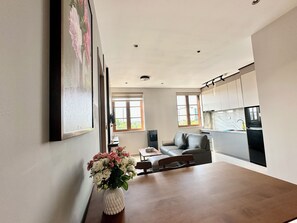 A modern kitchen with white cabinets, a marble backsplash, and a built-in oven. - Spacious modern 2BR apartment Phu Quoc (Phu Quoc)
