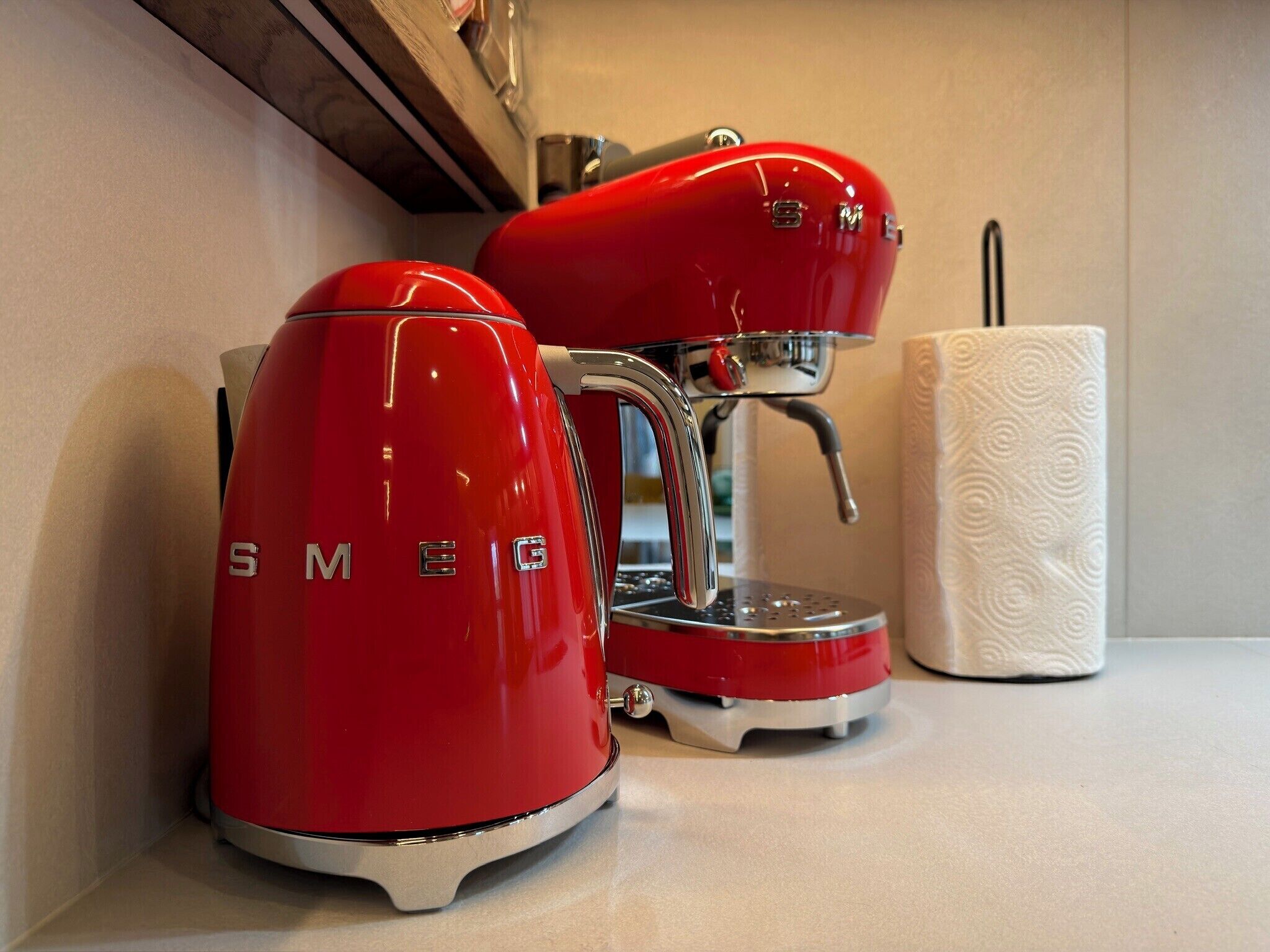 A red espresso machine with the brand name 'SMEG' on a countertop.