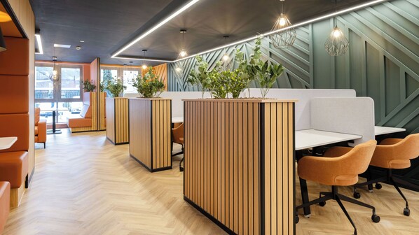 A modern office space with wooden partitions, ergonomic chairs, and pendant lighting. - Student Only Newarke Point (Leicester)