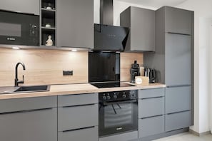 A modern kitchen with a Bosch microwave, oven, and coffee machine.