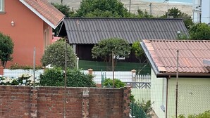 Ein Wohngebiet mit Blick auf den Ozean, einer Ziegelmauer und einem Tennisplatz.