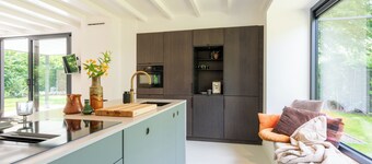 Experience the ultimate vacation feeling in this secluded vacation home with a private wellness area, wood-burning stove, designer interior, and air conditioning