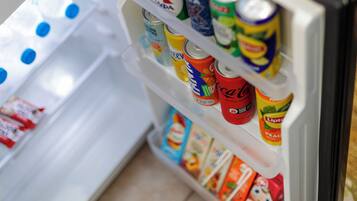 A refrigerator stocked with various beverages and snacks.