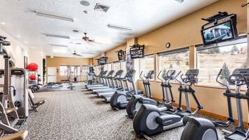 A gym with treadmills, stationary bikes, and weight machines.