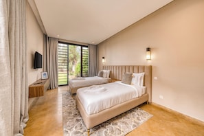 A hotel room with two beds, a TV, a window with curtains, and a view of greenery outside. - Riad Safran Al Maaden Golf – Marrakech (Marrakech)