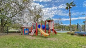 A playground with a slide, climbing structures, and a small shelter. - 3111 Poolside Villa, New Listing Deal ~ Book Sept 7th Today!  Pools, Bar, Gym (Destin)