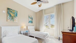 A hotel room with two beds, a desk, a television, and artwork on the walls. - 3111 Poolside Villa, New Listing Deal ~ Book Sept 7th Today!  Pools, Bar, Gym (Destin)