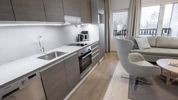 A modern kitchen with a Siemens dishwasher, a coffee maker, and a built-in oven.