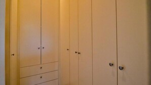 A closed wardrobe with multiple doors and drawers. - Khaya Elihle Guest House (Sabi River Eco Estate)