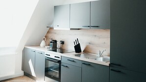 A modern kitchen with a built-in oven, a sink, and a countertop.