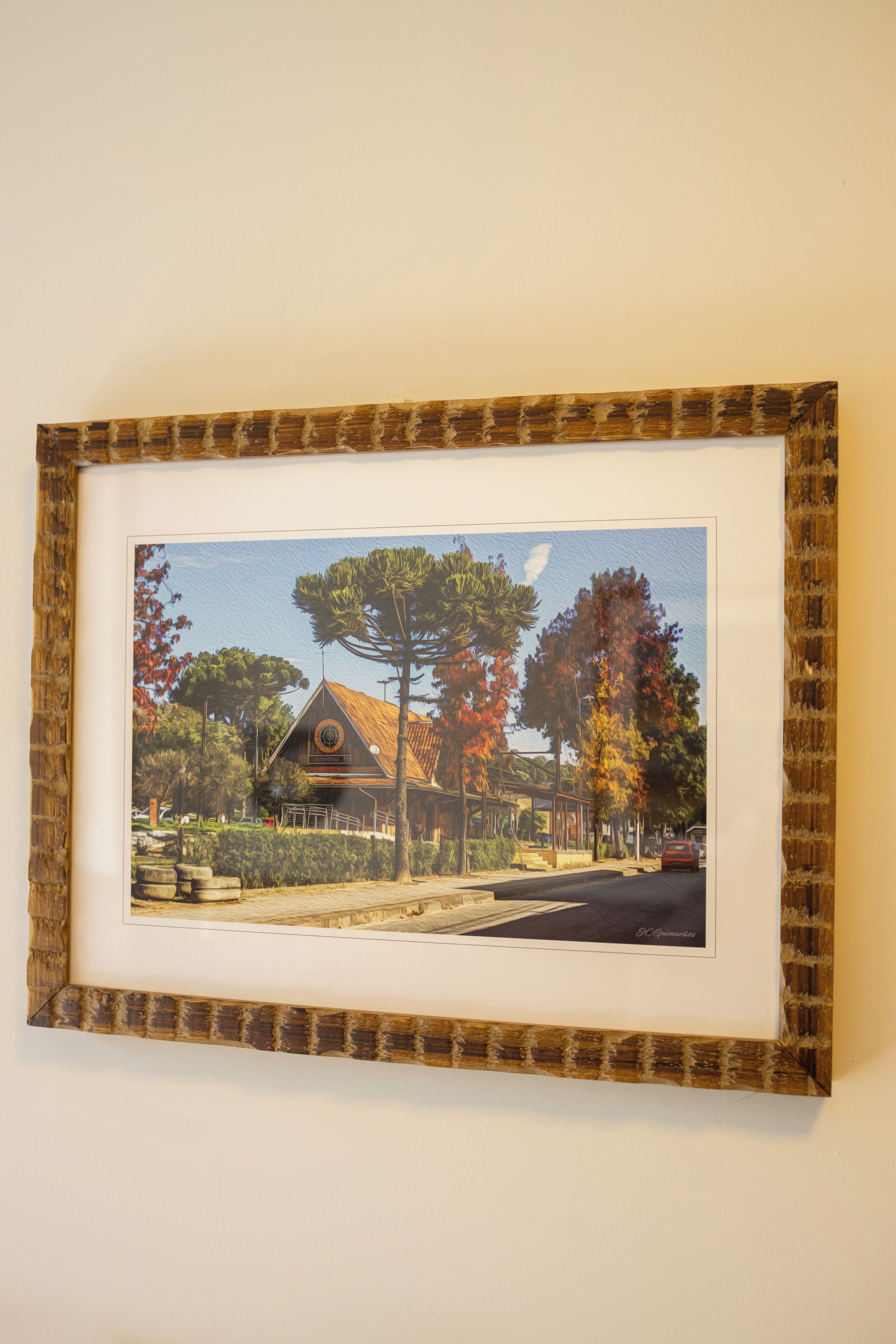 A framed picture of a building with a distinct roof and a sign that reads 'ABBEY MESSIA'.